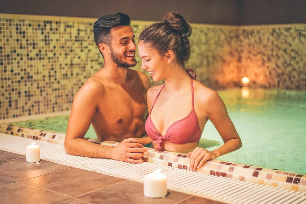 Couple Relaxing in a Warm Pool Hydromassage at Hotel Spa